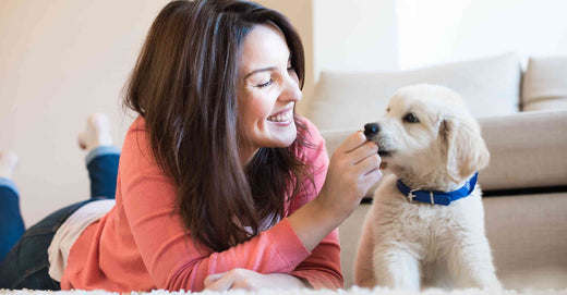 woman laying next to dog