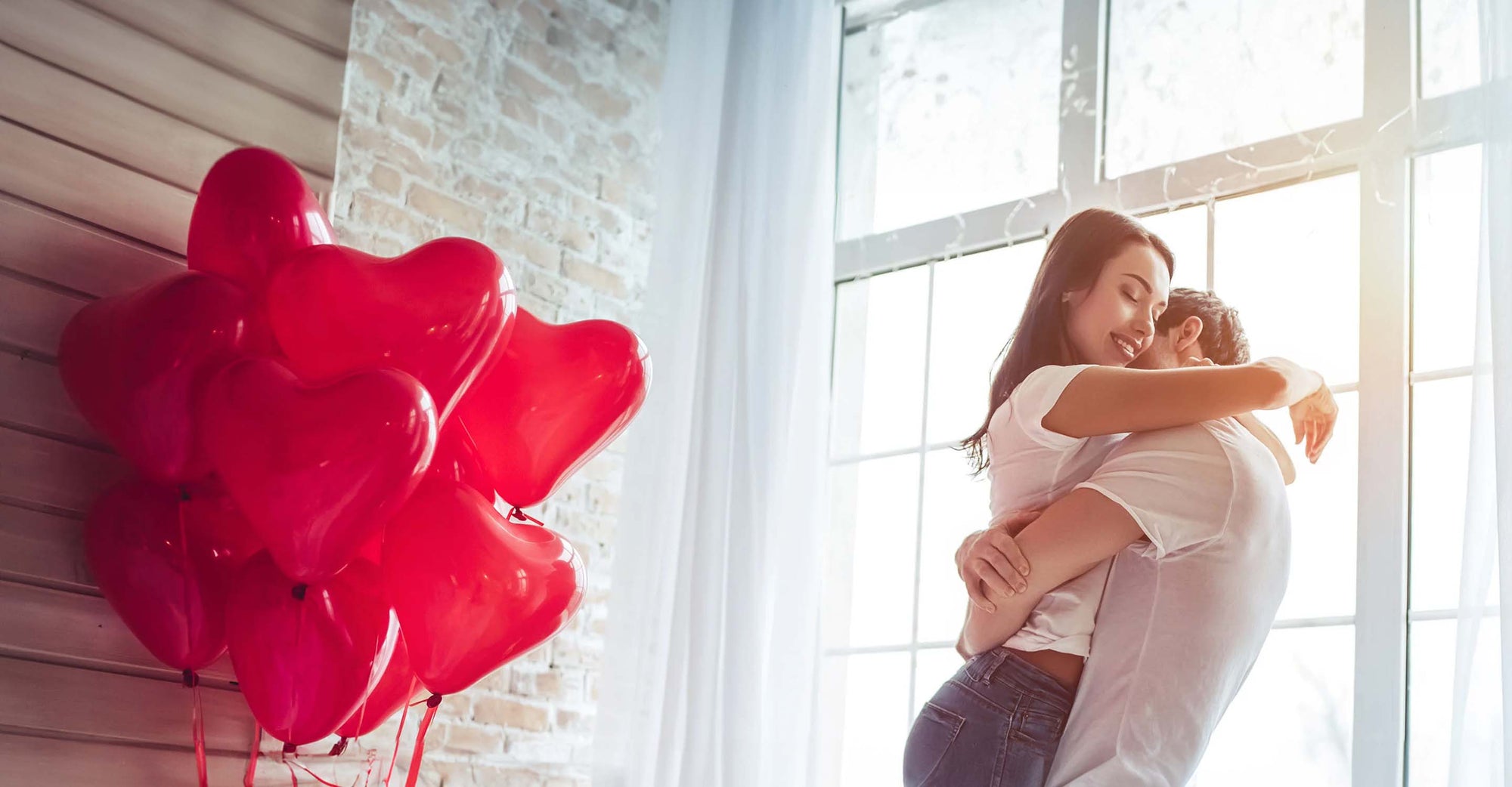 Couple embracing near heart-shaped flowers