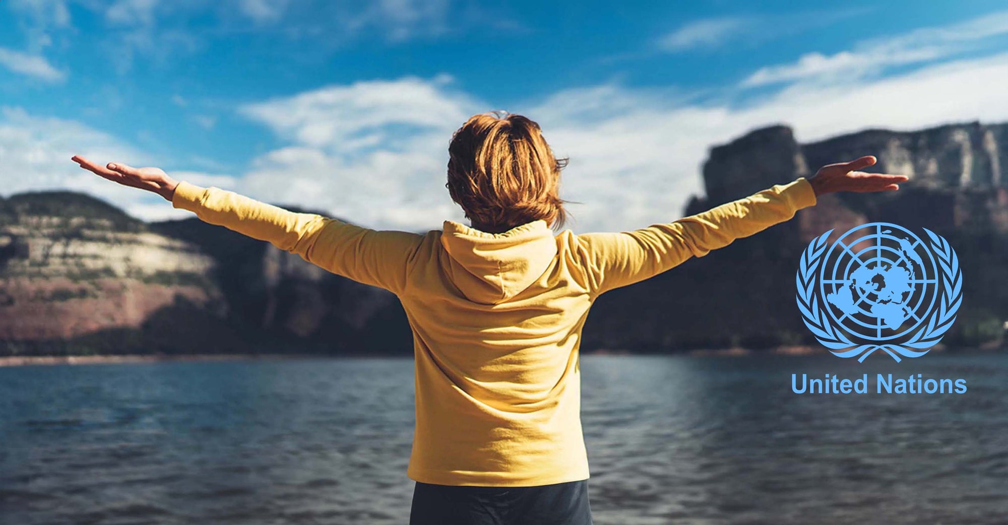 woman stretching her arms in front of a lake