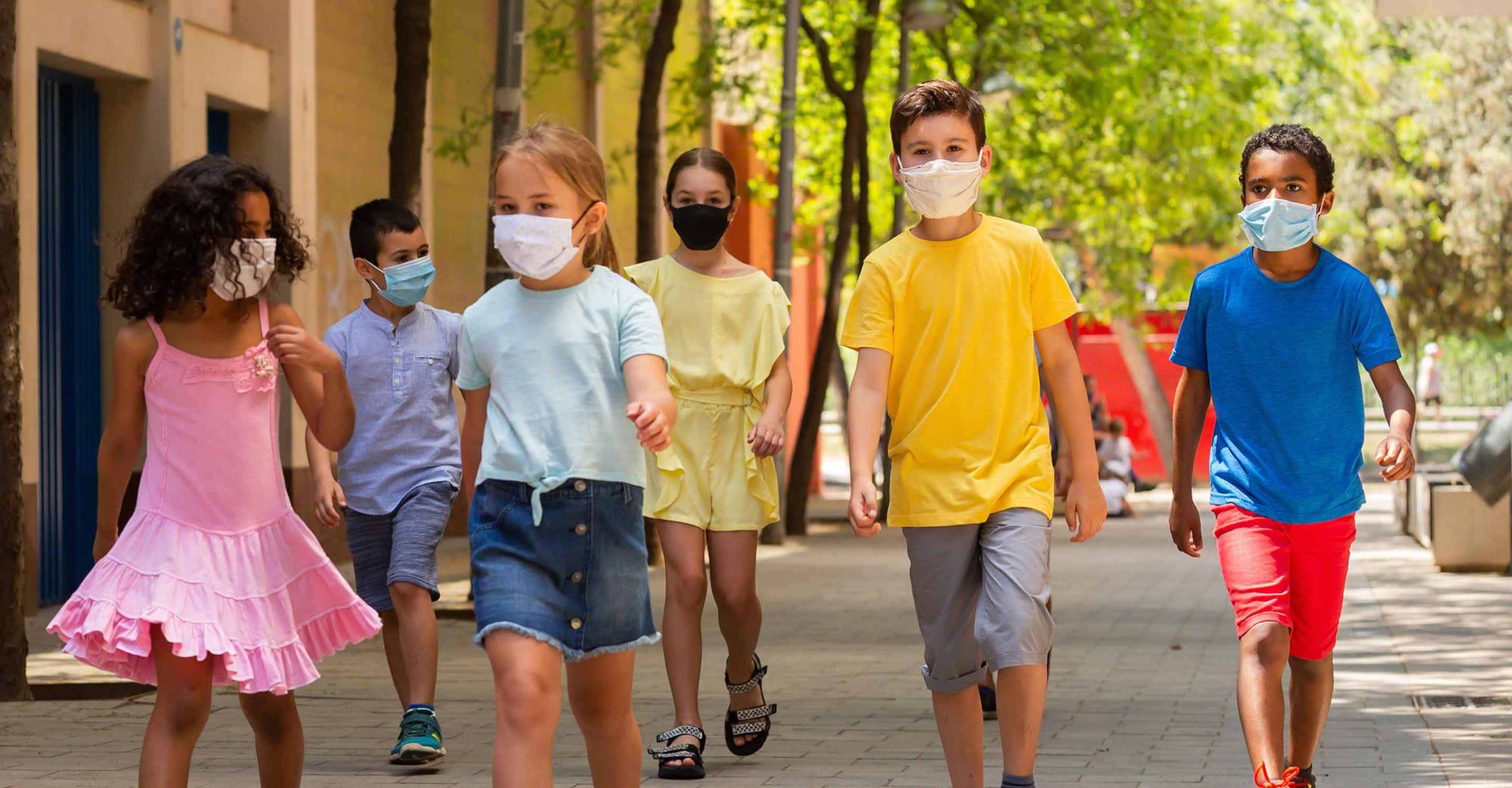 Kids with masks walking to school