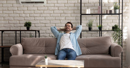 Man relaxing on couch in clean home